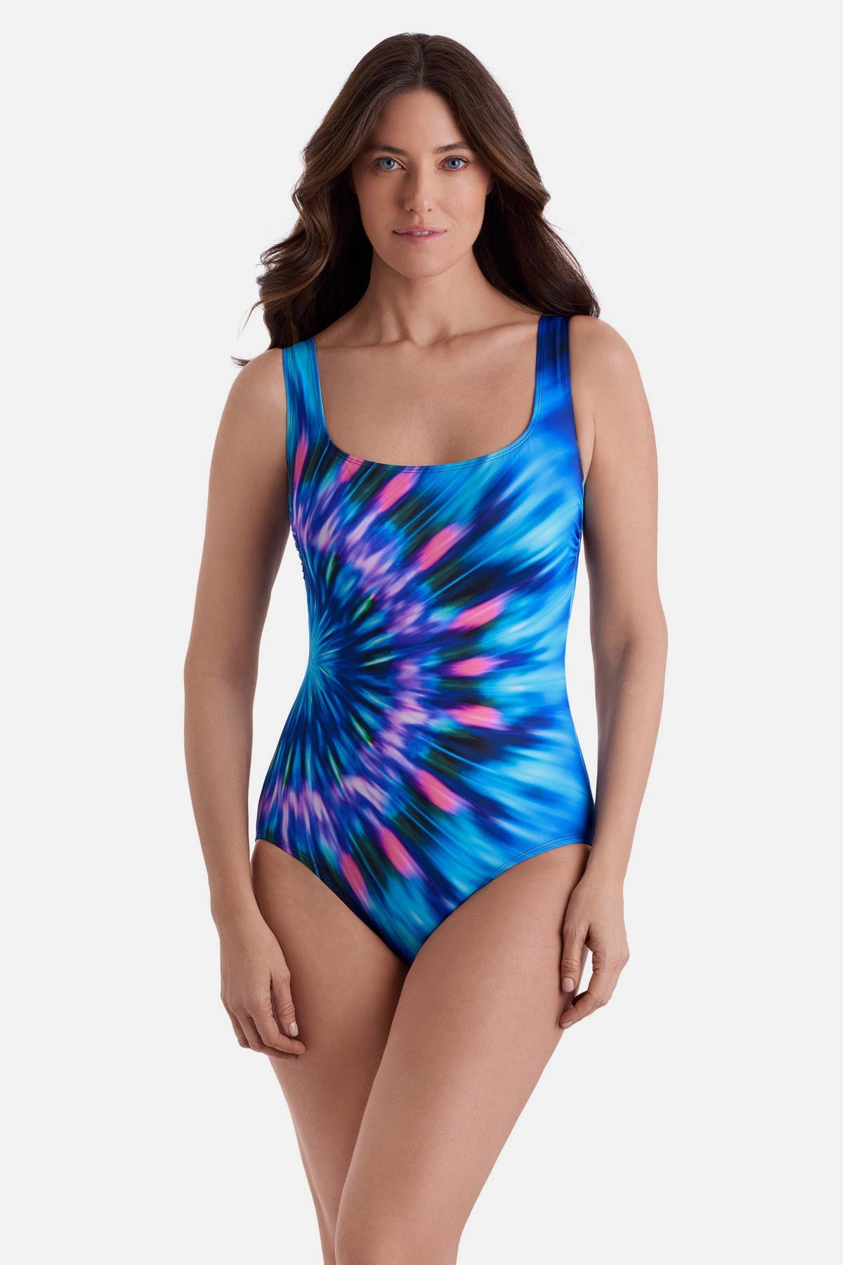 Woman wearing a pink and blue tie dye one-piece swimsuit