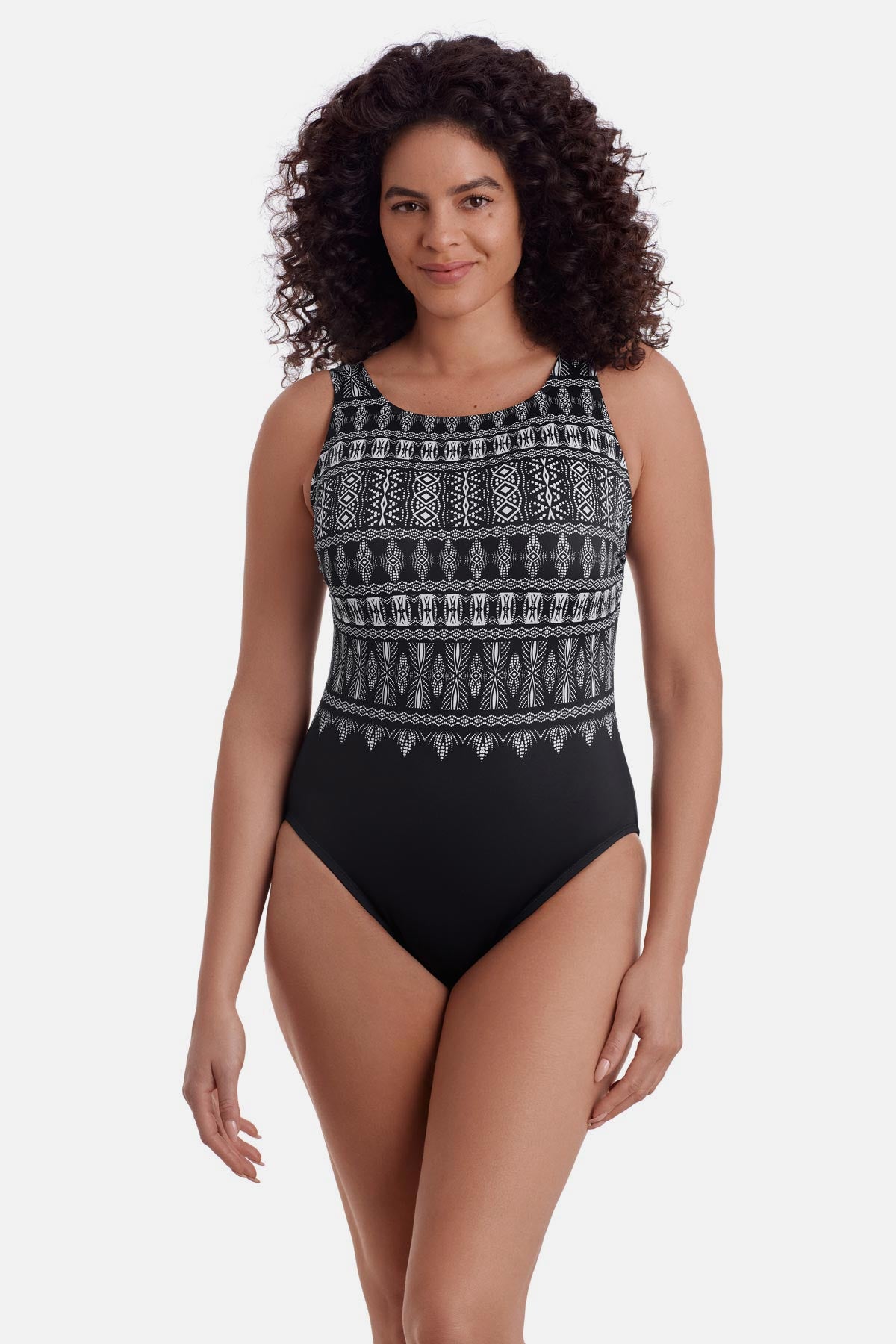 Woman wearing a black and white tribal printed one-piece swimsuit with a high neckline