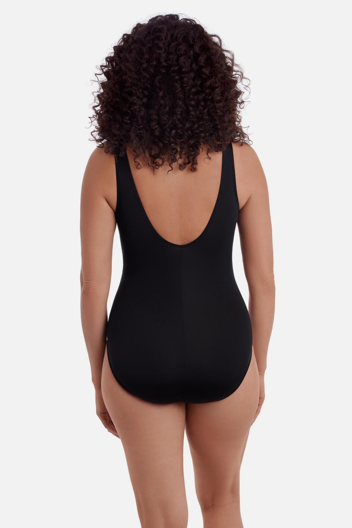 Woman wearing a black one-piece swimsuit with a scoop back