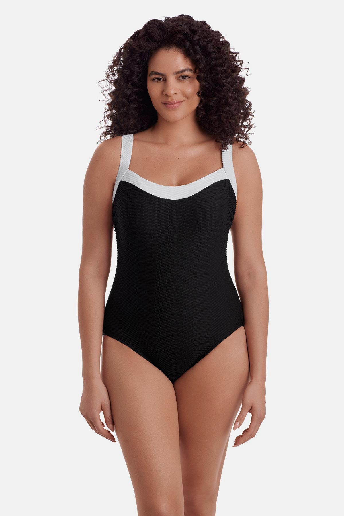 Woman wearing a black one-piece swimsuit with white trim along the straps and neckline