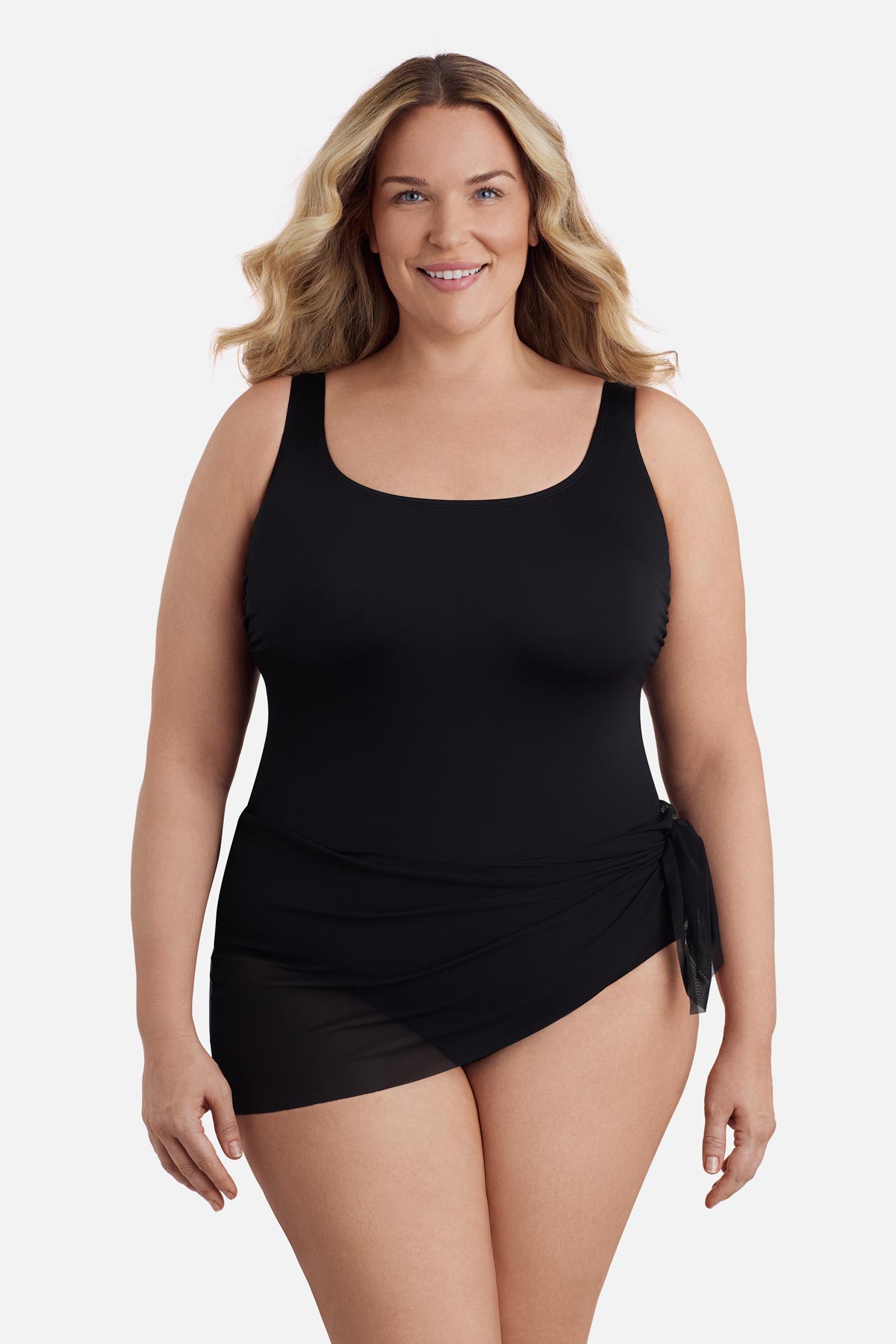 Woman wearing a black one-piece swimsuit with a mesh sash around the waist