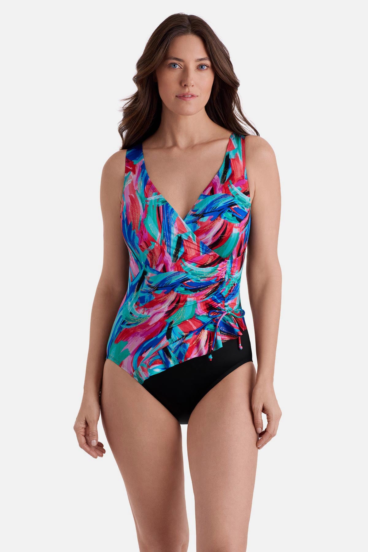 Woman wearing a multicolored abstract printed one-piece swimsuit with a side tie detail