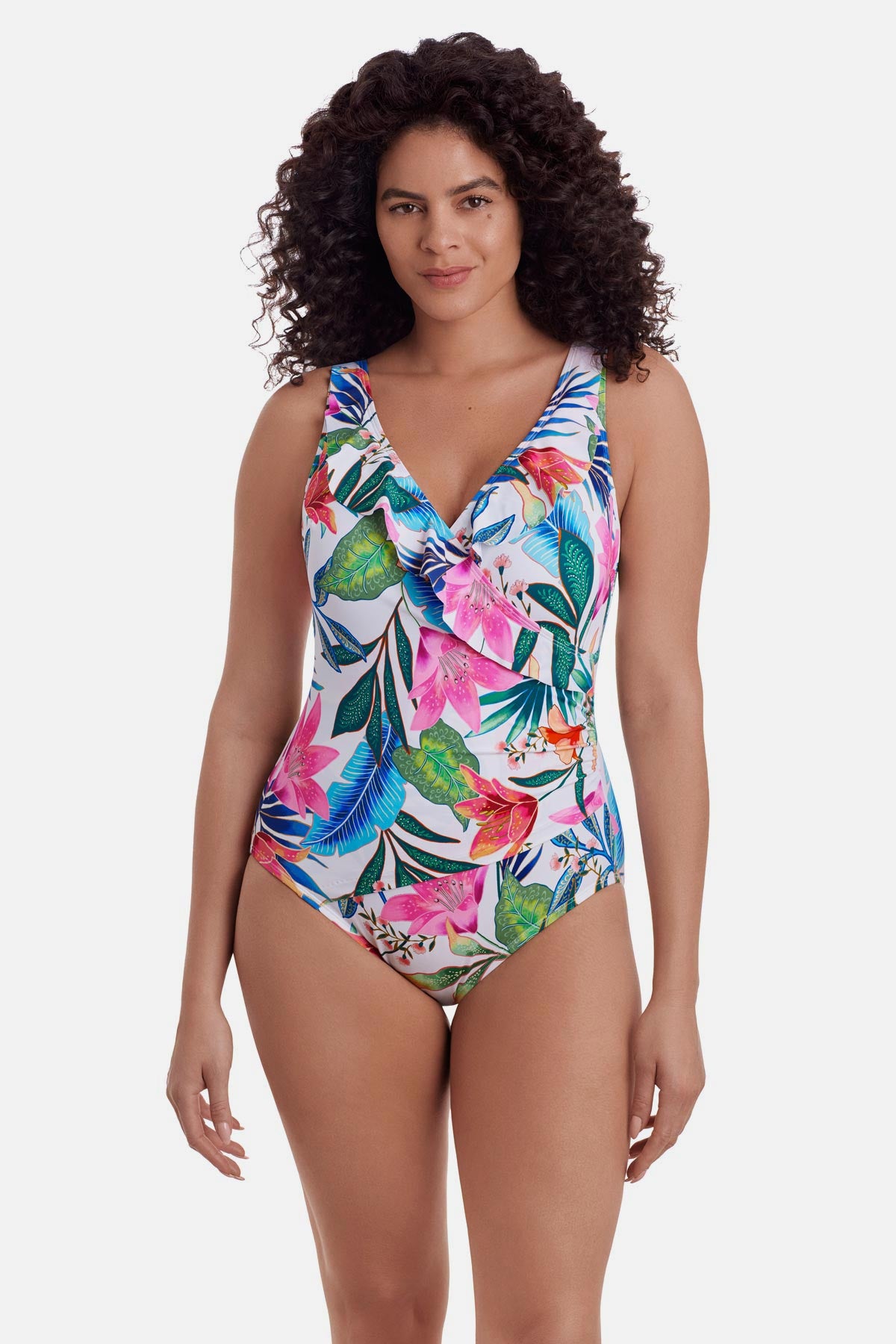 Woman wearing a multicolored floral printed one-piece swimsuit with ruffles along the neckline