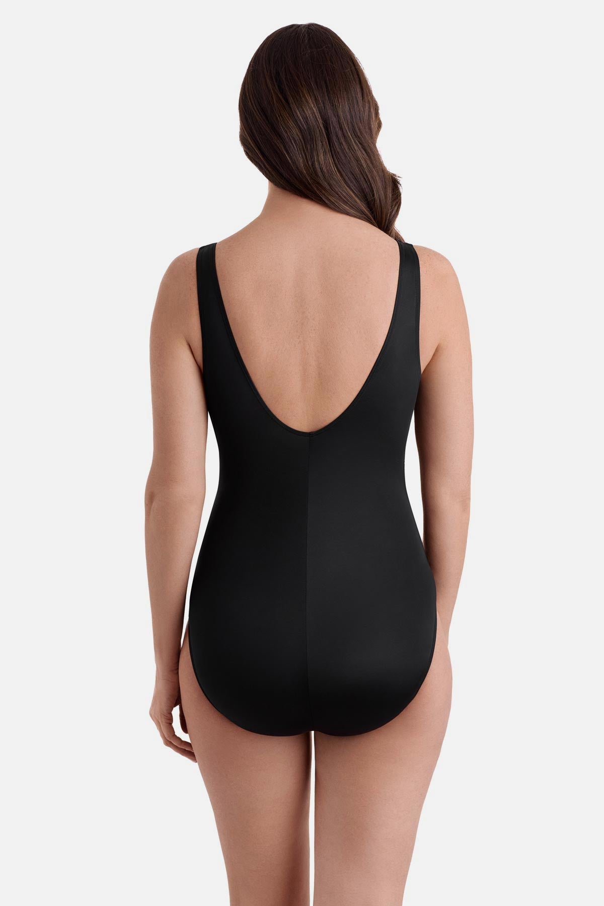 Woman wearing a one piece with a scoop back