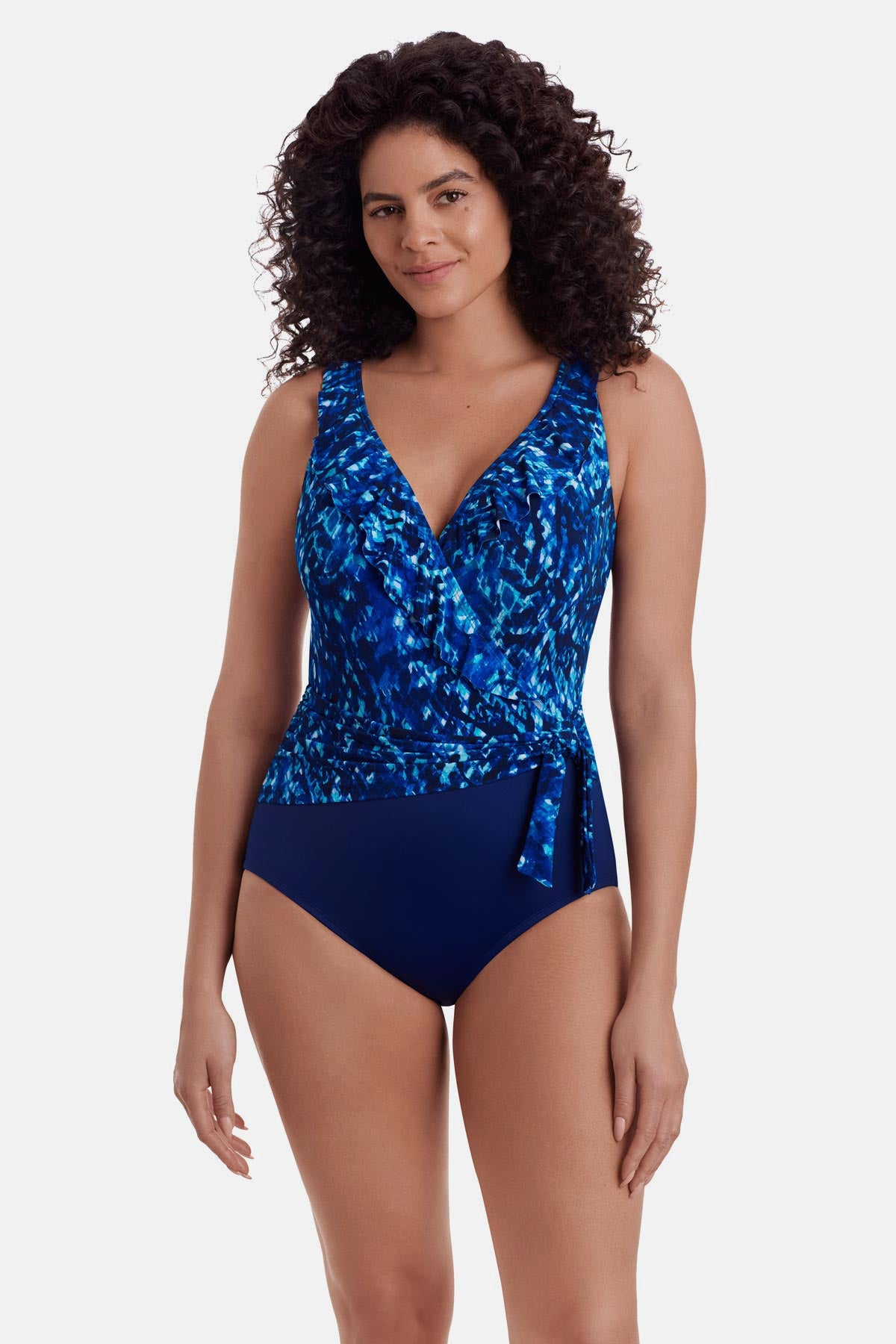 Woman wearing a blue abstract printed one-piece swimsuit with a side tie