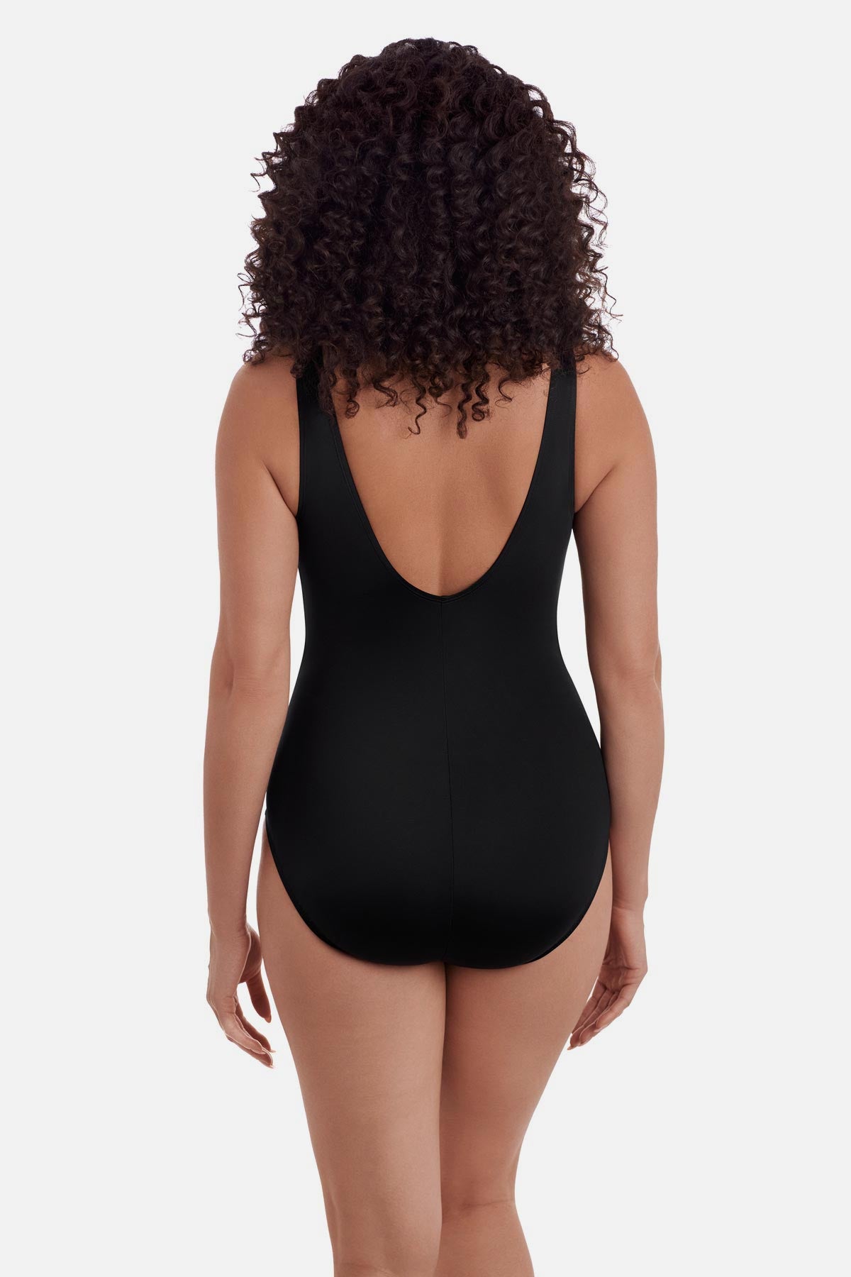 Woman turned away wearing a one-piece swimsuit with a scoop back
