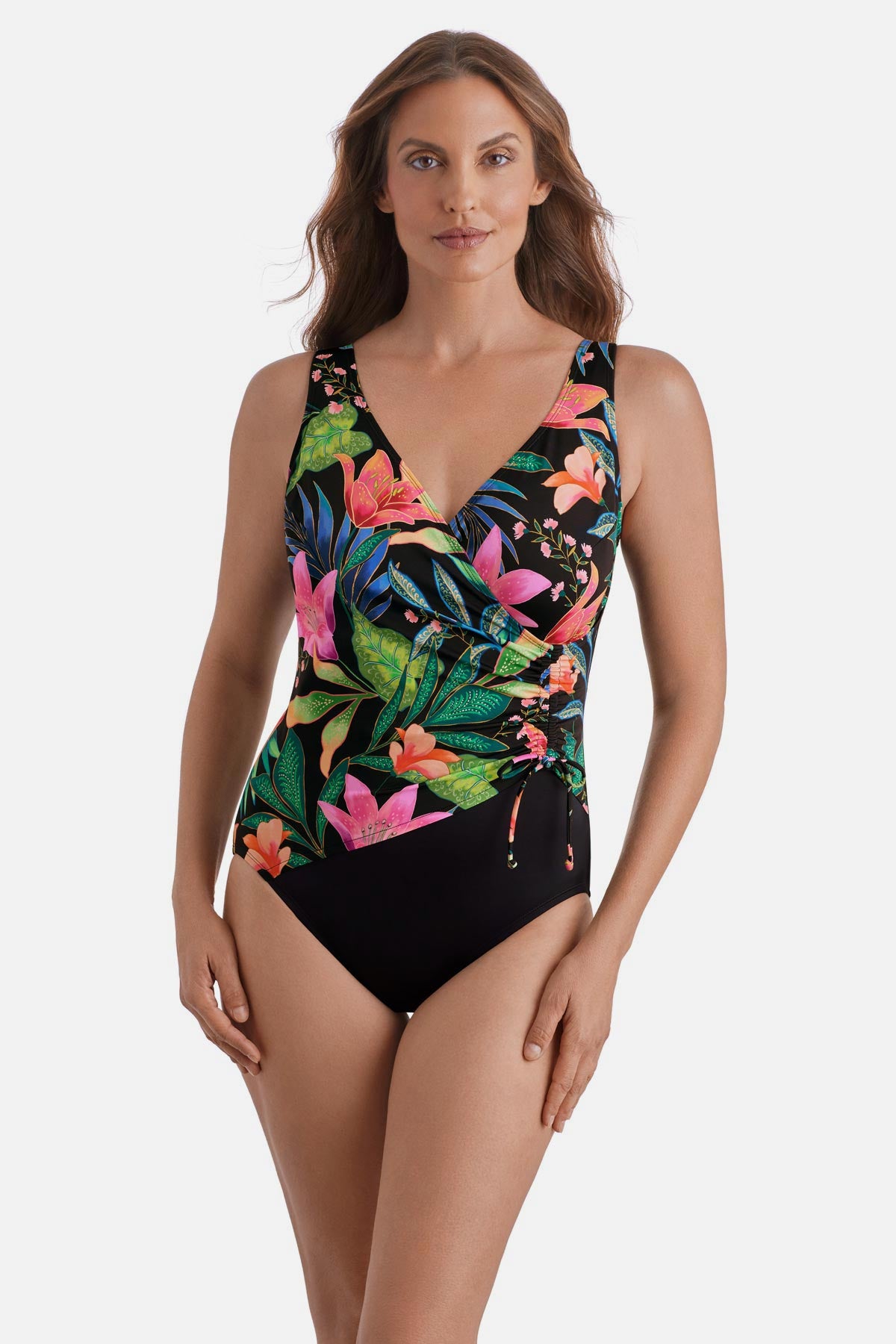 Woman wearing a multicolor floral printed one-piece swimsuit with side tie detail