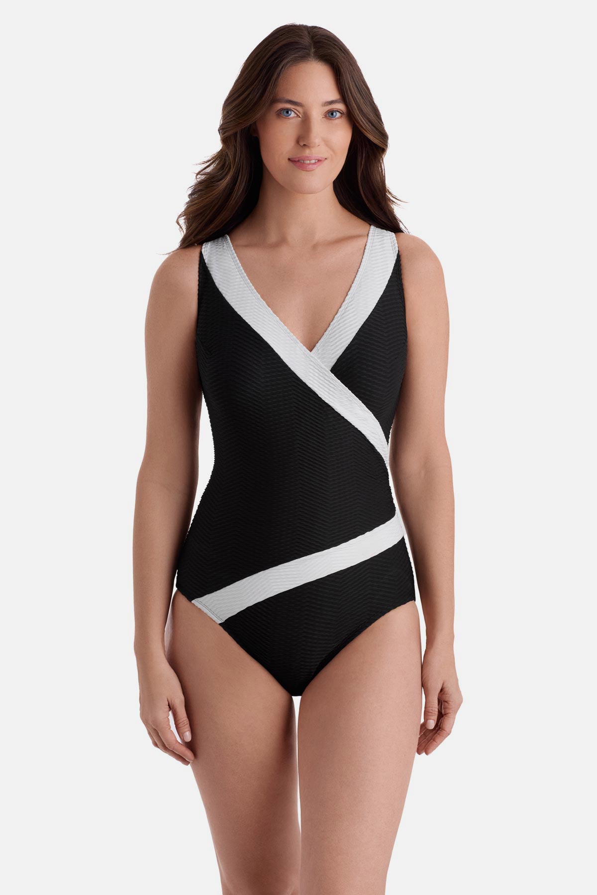Woman wearing a black one-piece swimsuit with white textured trim