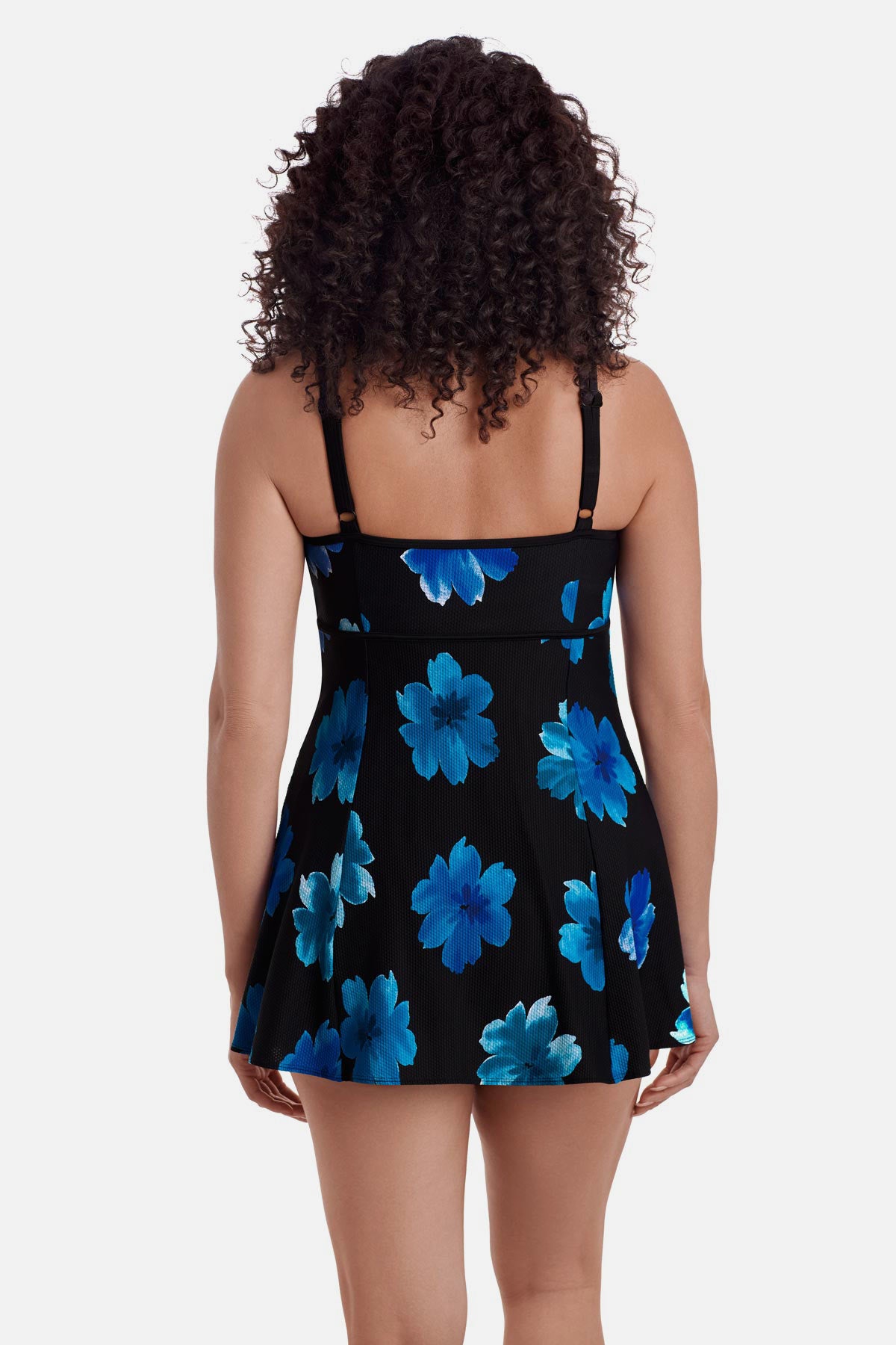 Woman turned away wearing a black swim dress with large blue flowers