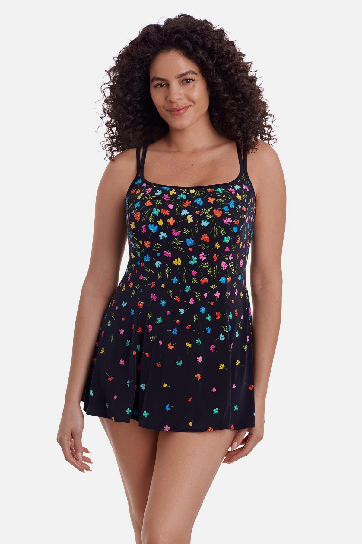 Woman wearing a black swim dress with small multicolored flowers