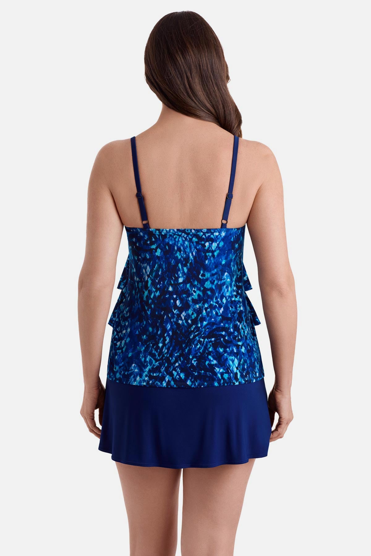 Woman turned away wearing a blue abstract print ruffle skirtini swimsuit