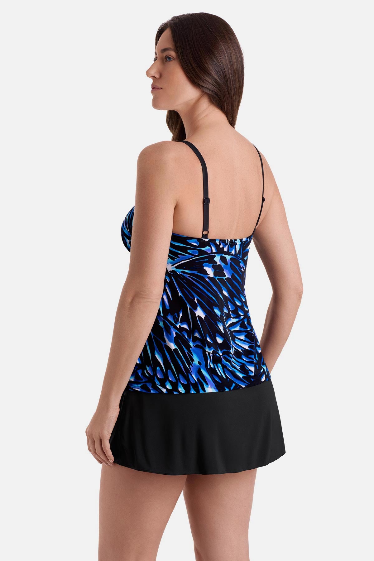 Woman turned left wearing a blue abstract printed faux ruffle skirtini swimsuit