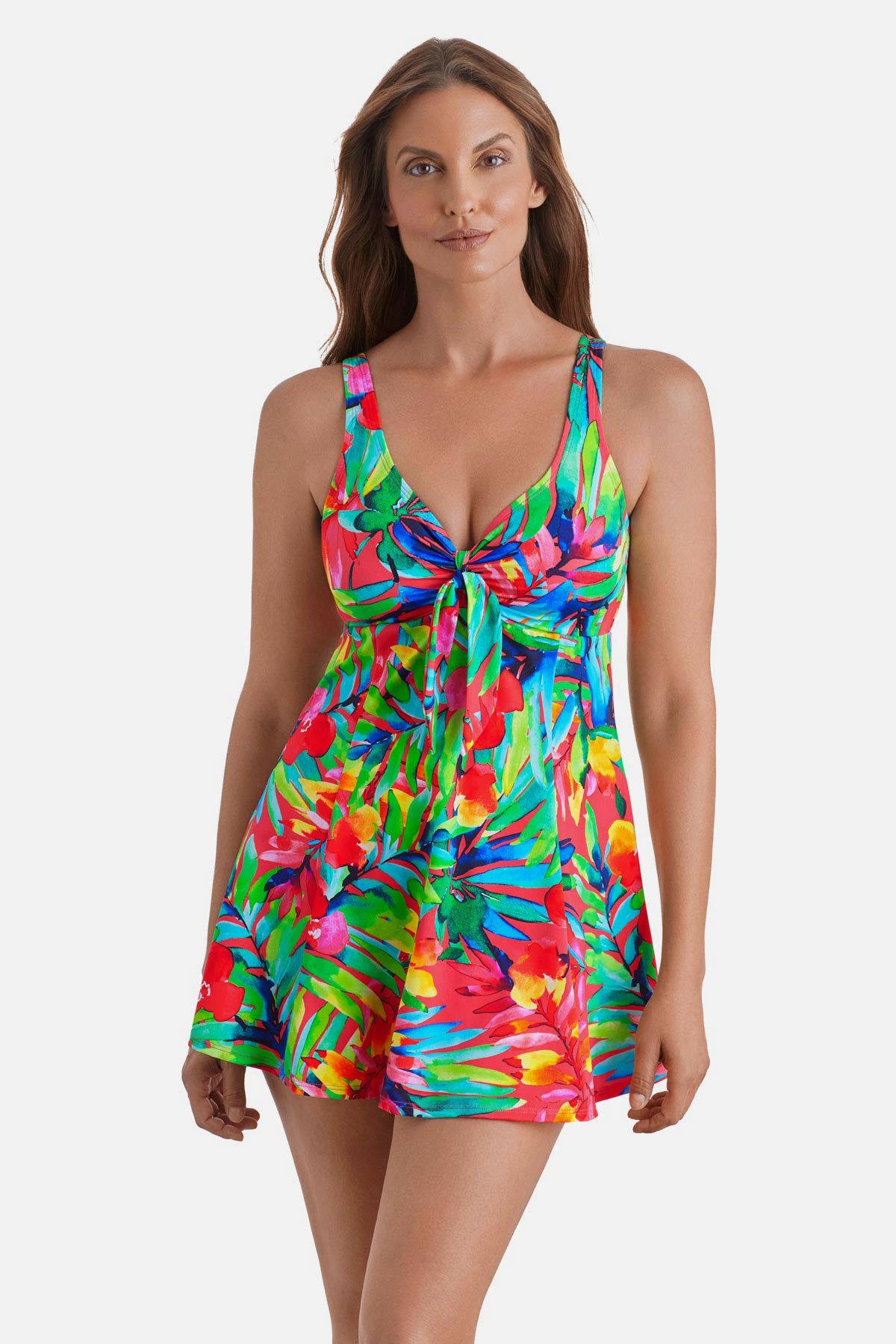 Woman wearing a multicolor palm leaf printed swim dress with a tie in the front