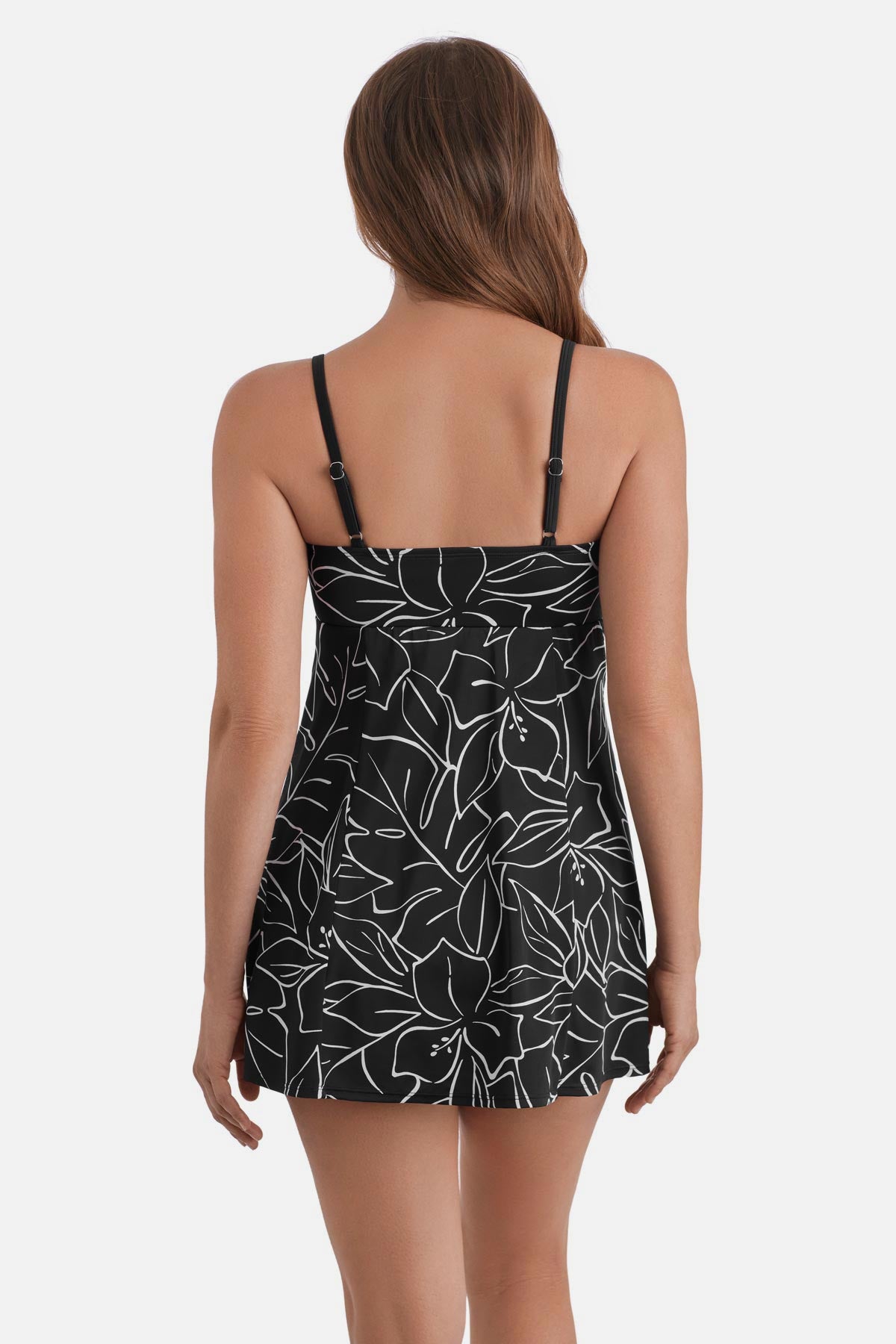Woman turned away wearing a black and white floral outline printed swim dress