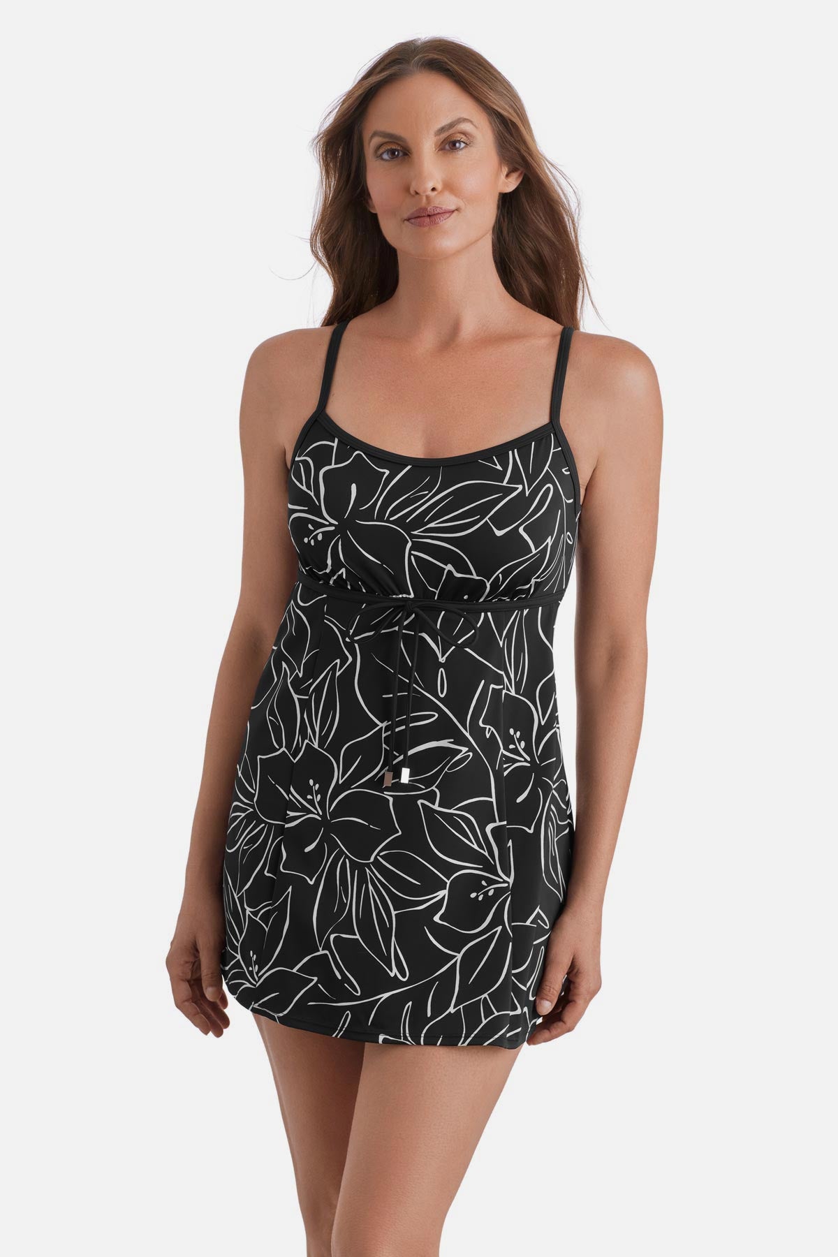 Woman wearing a black and white floral outline printed swim dress