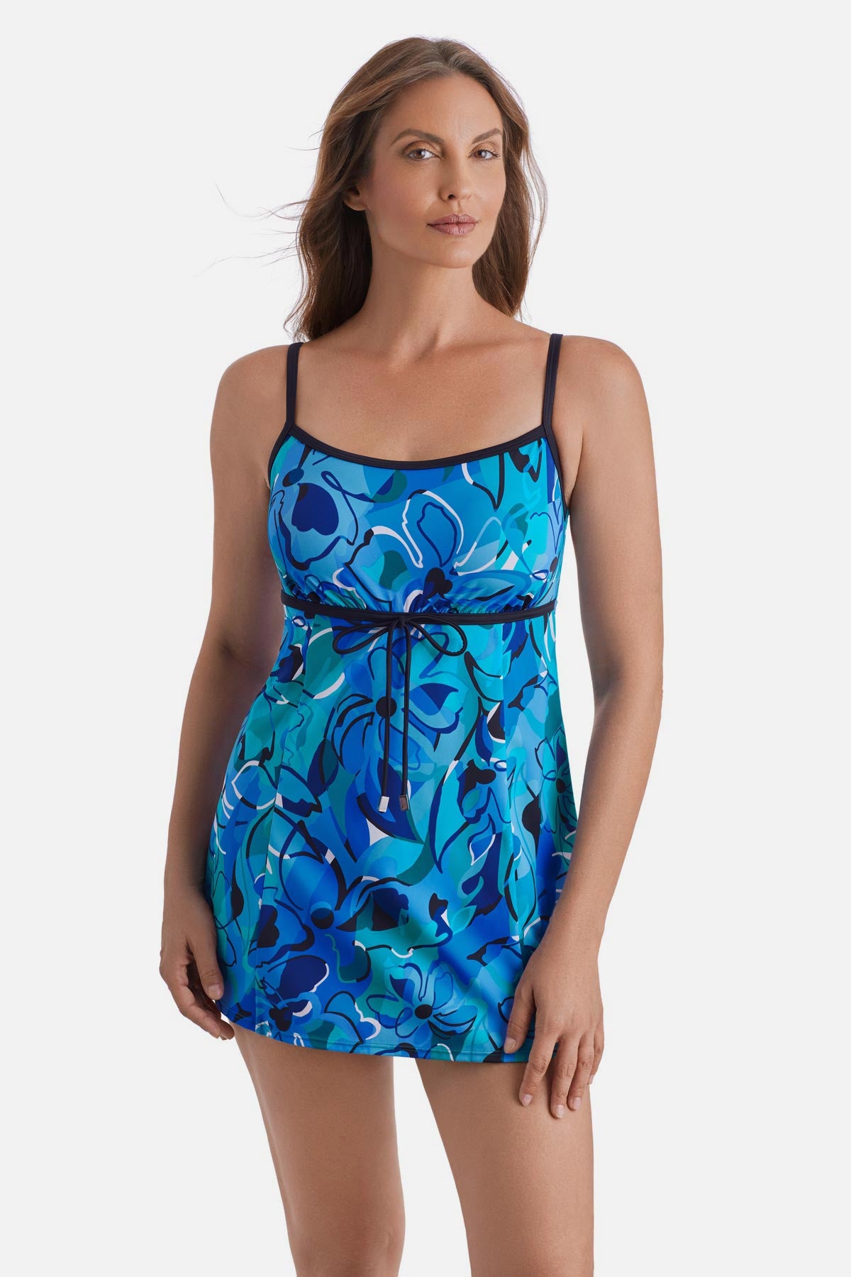 Woman wearing a blue floral printed swim dress with a tie around the waist