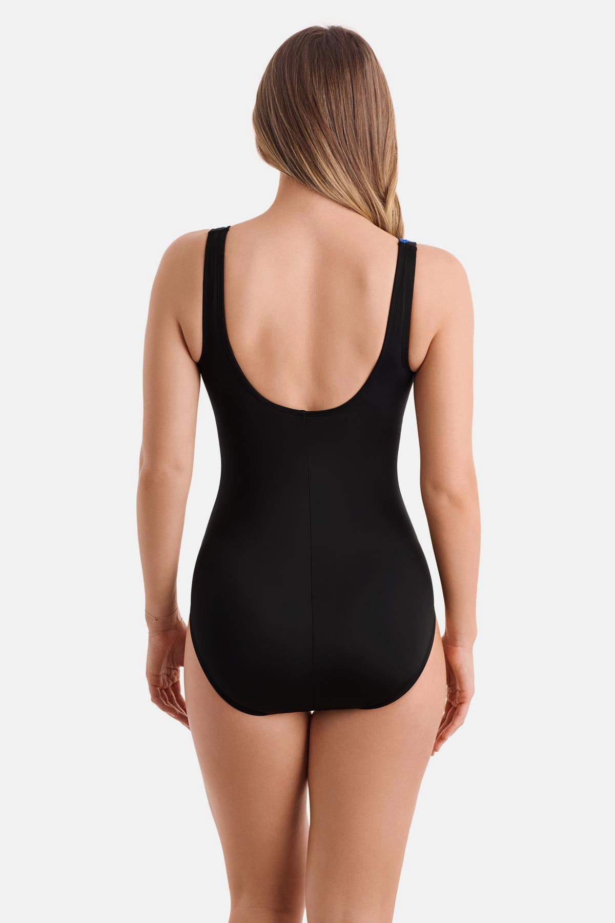 Woman turned away wearing a blue radial print one-piece swimsuit