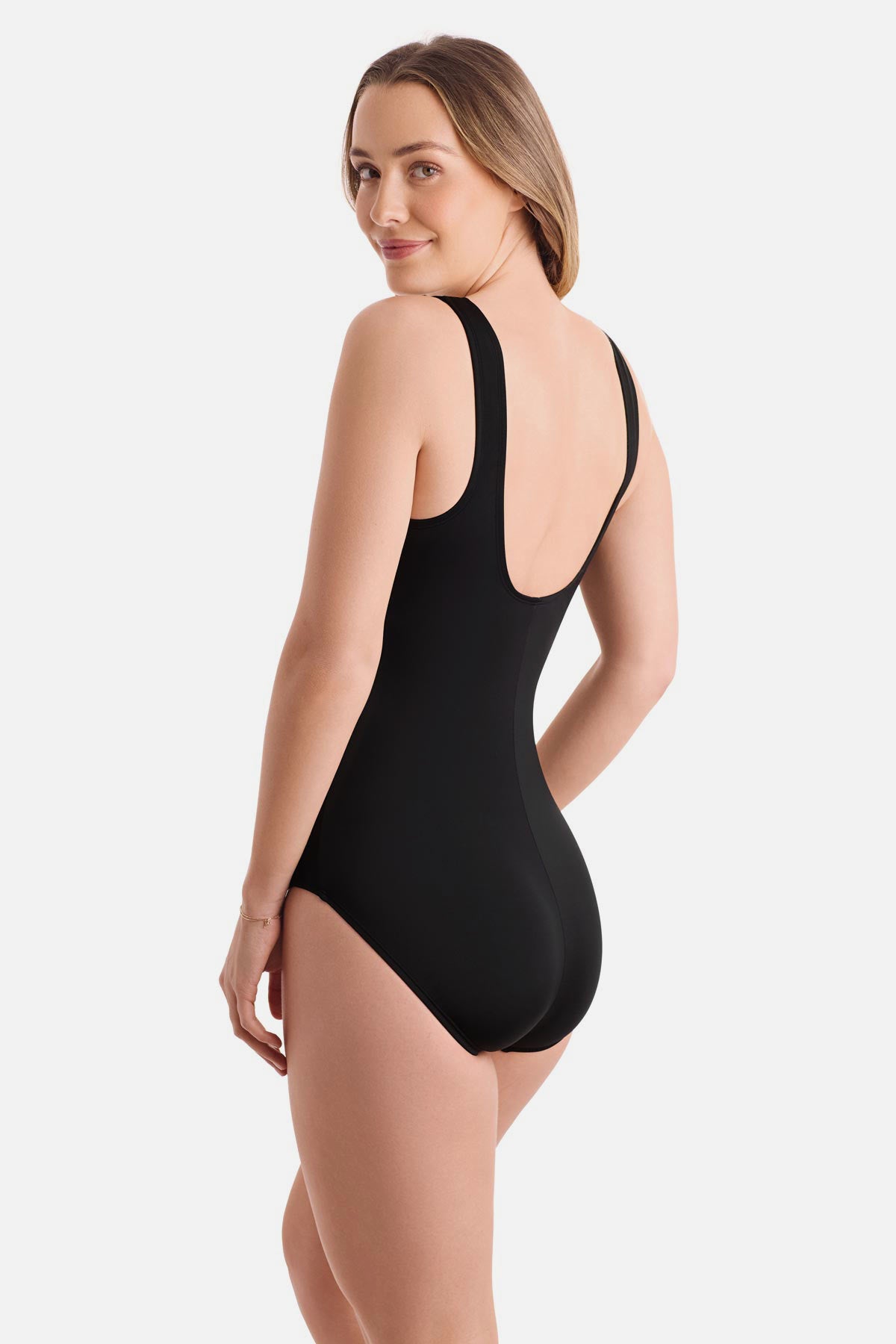 Woman turned left wearing an electric rainbow printed one-piece swimsuit
