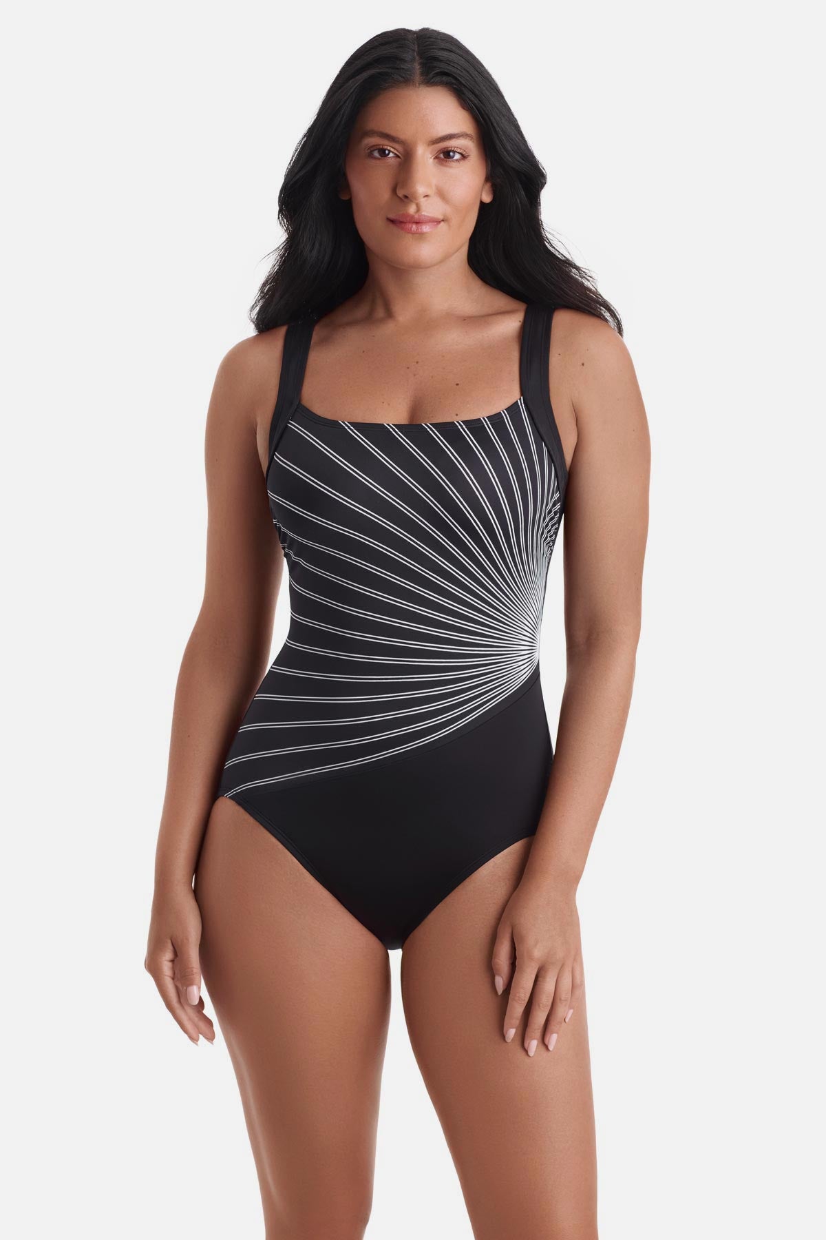 Woman wearing a black and white radial pattern one-piece swimsuit
