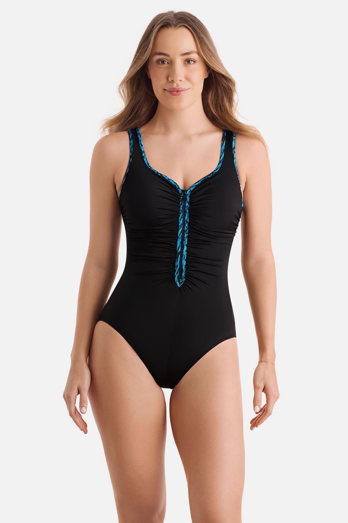 Woman wearing a black one-piece swimsuit with a blue braided piping on the edges