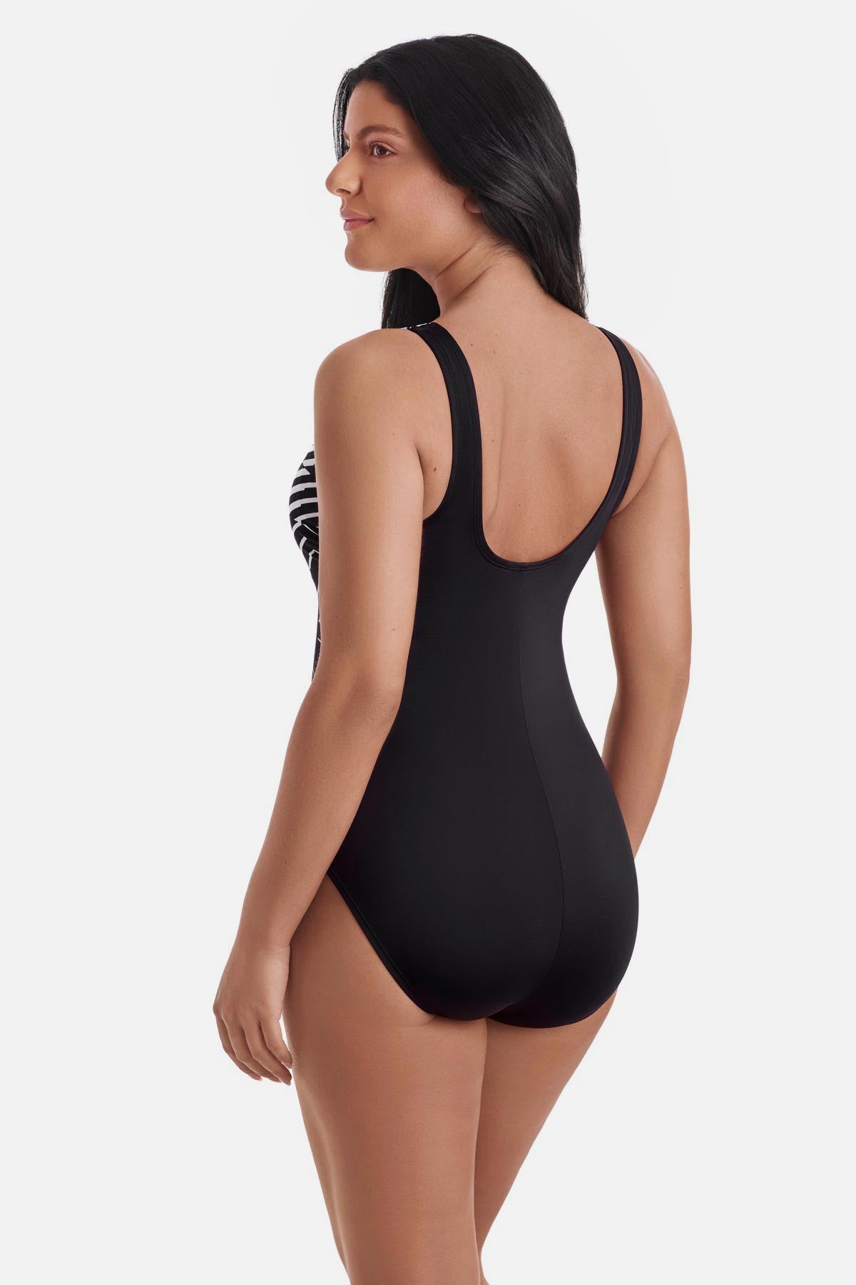 Woman turned left wearing a black and white abstract pattern one-piece swimsuit