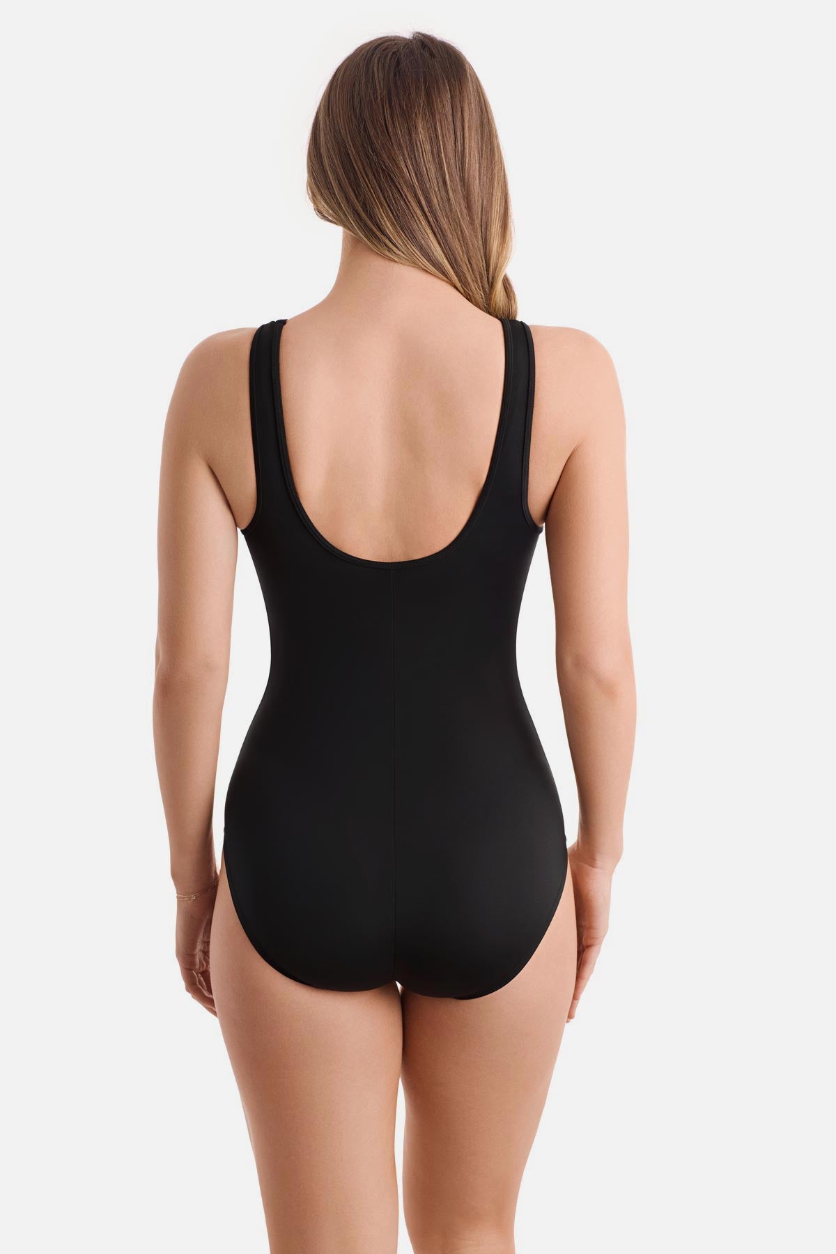 Woman turned away wearing a blue tile printed one-piece swimsuit