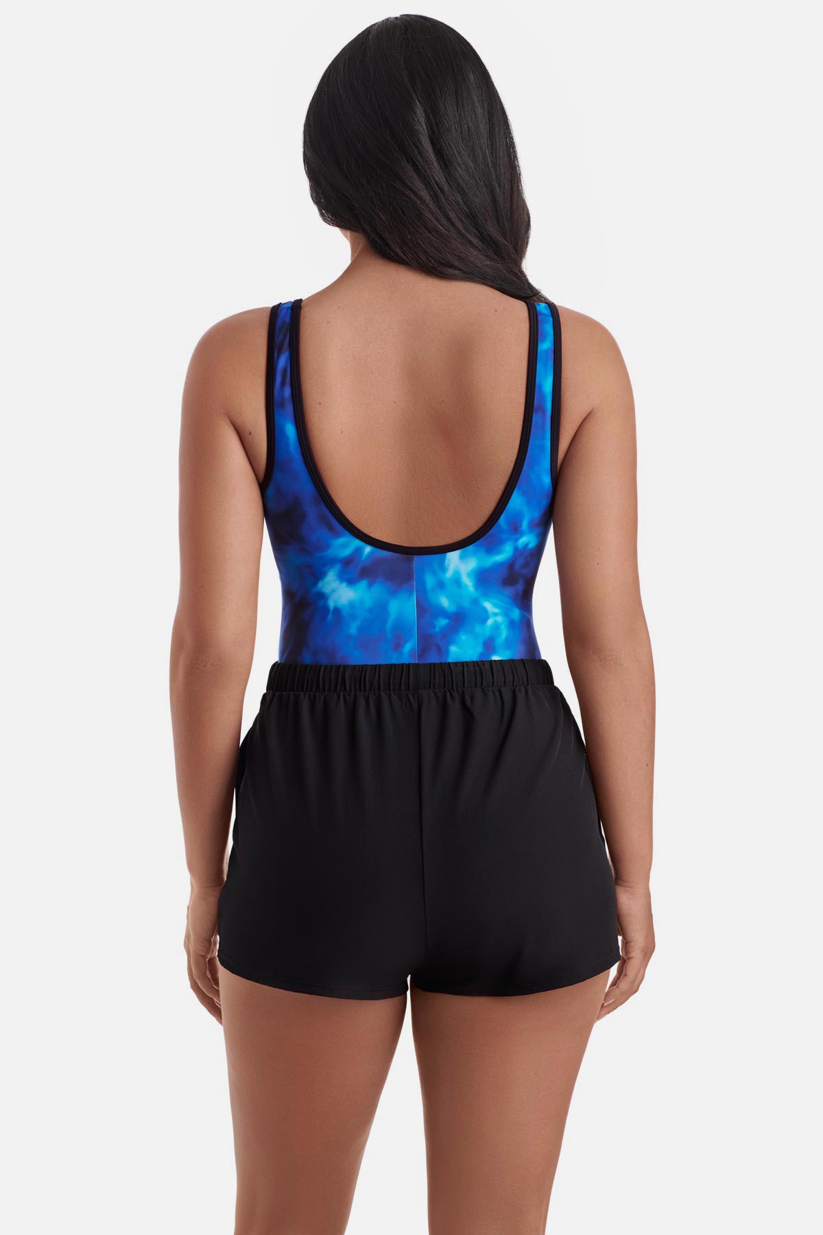 Woman turned away wearing a black and blue water print swim romper