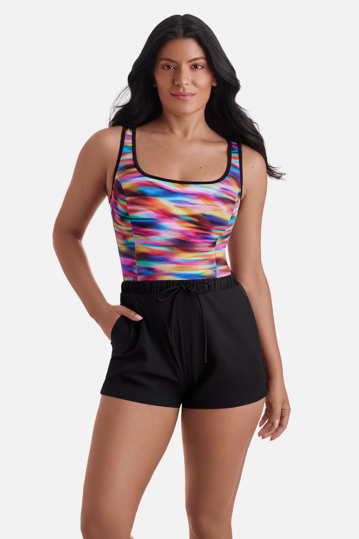 Woman wearing a rainbow tie dye one-piece swim romper