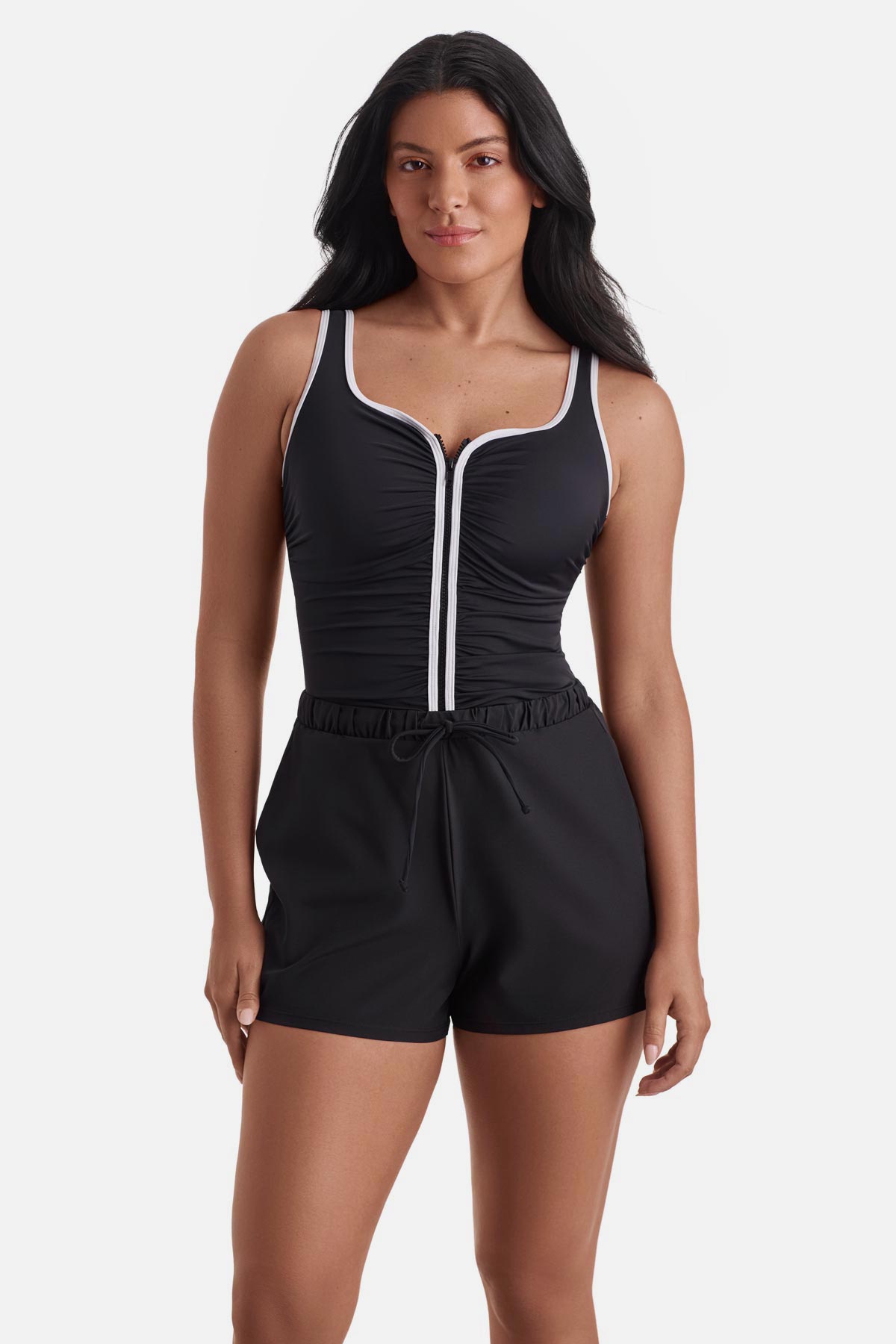 Woman wearing a black and white one-piece swim romper