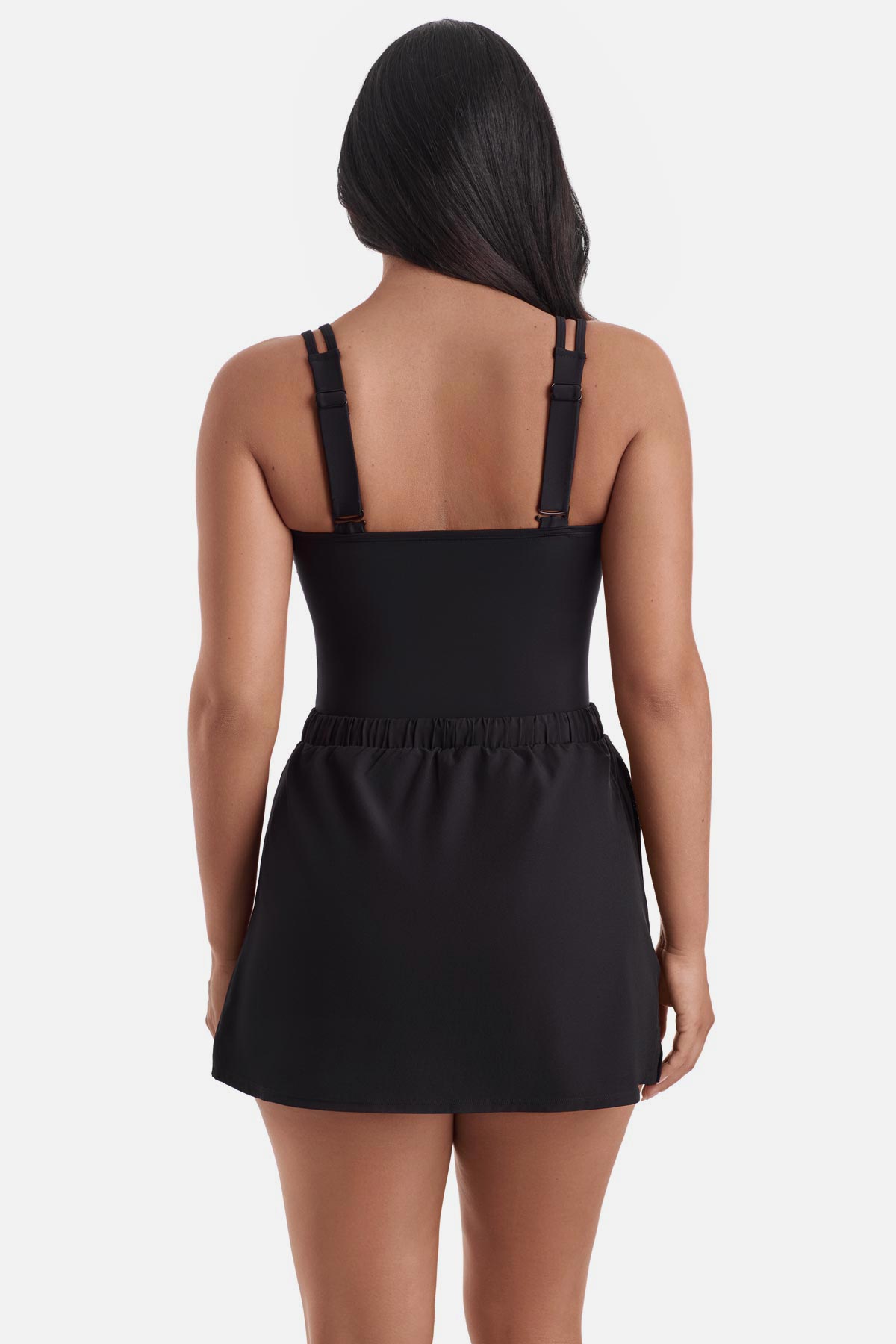 Woman turned away wearing a blue tile print one-piece swim dress