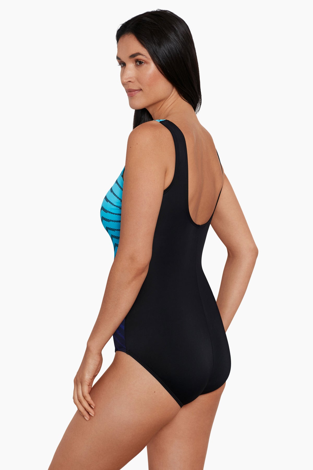Woman faced left wearing a blue ombre zig zag pattern one-piece swimsuit
