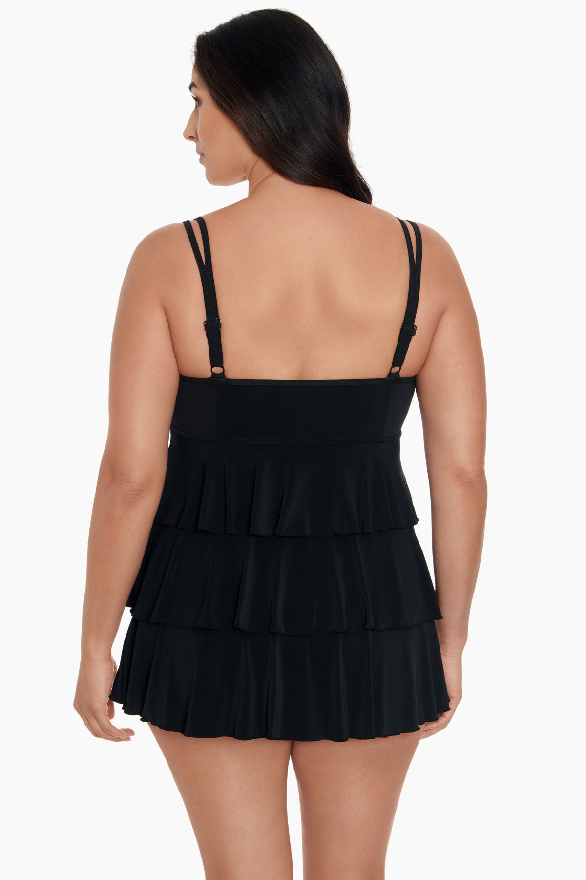 Woman faced away wearing a black swim dress with ruffled tiers