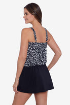 Woman turned left wearing a black and white scaley printed blouson swim dress