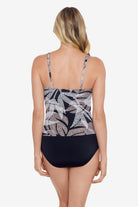 Woman turned away wearing a dotted leaf pattern one-piece swimsuit