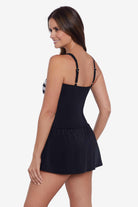 Woman turned left wearing a black and white tie dye skater swim dress