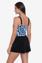 Woman turned left wearing a multicolored abstract printed skort romper
