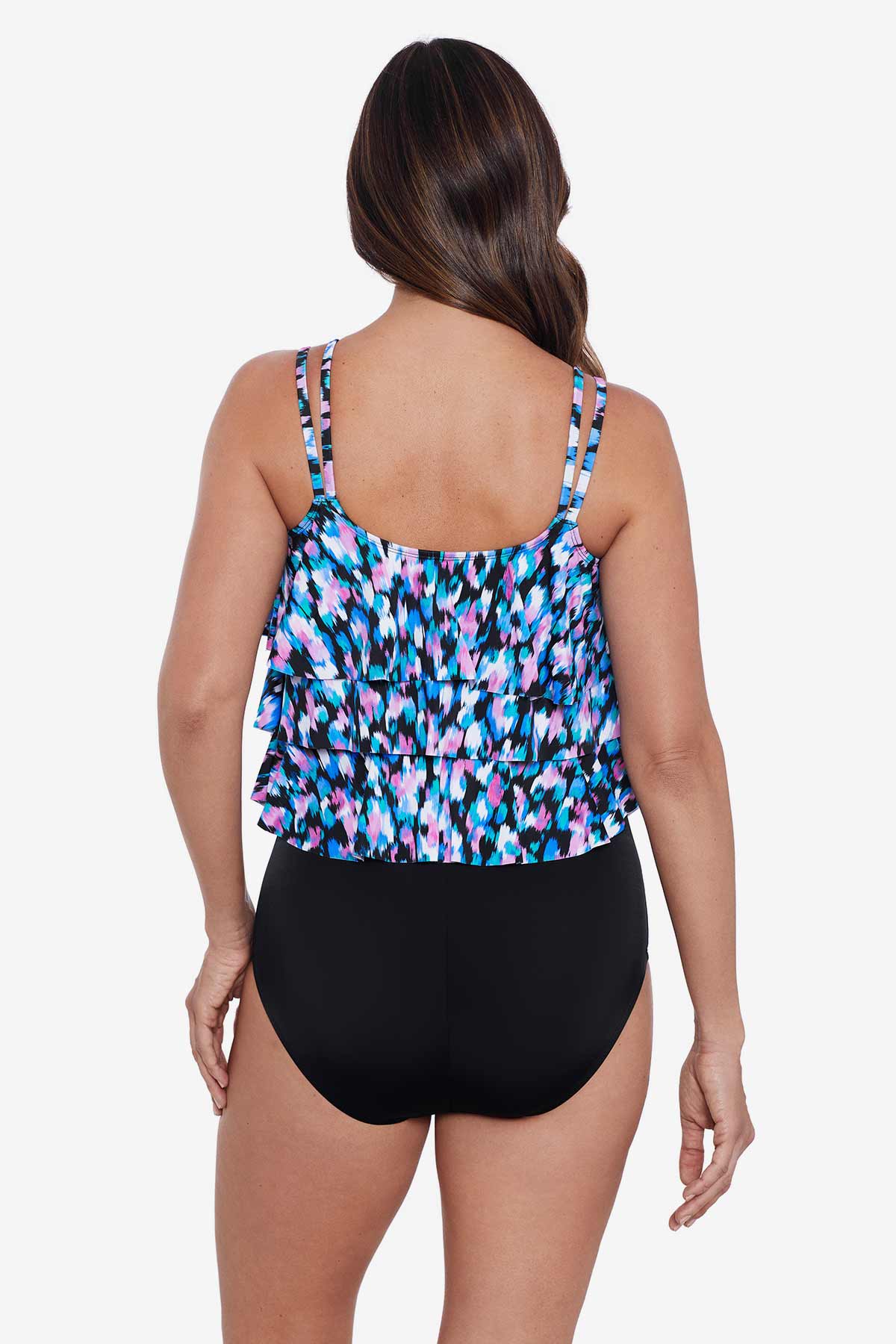 Woman faced away wearing a multicolored abstract printed tiered tankini top