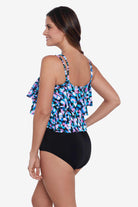 Woman faced left wearing a multicolored abstract printed tiered tankini top