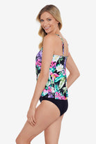 Woman turned left wearing a multicolored tropical printed ruffle tiered tankini top