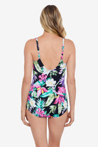 Woman faced away wearing a multicolored tropical printed one-piece swimsuit