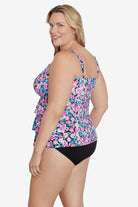 Woman turned left wearing a multicolored floral printed tiered ruffle tankini top