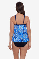 Woman faced away wearing a blue and white abstract pattern flowy tankini top