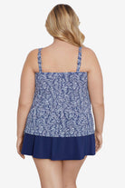 Woman turned away wearing a blue and white abstract pattern tankini top