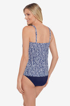 Woman turned left wearing a blue and white abstract pattern tankini top