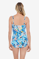 Woman faced away wearing a multicolored small floral printed one-piece swimsuit 