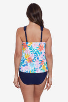 Woman faced away wearing a multicolored tropical print tankini top