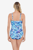 Woman faced away wearing a blue and white feather/leaf pattern one-piece swimsuit