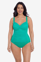 Woman wearing a seafoam green one-piece swimsuit