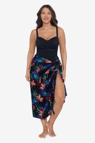 Woman wearing a tropical printed swim wrap cover up with tassels