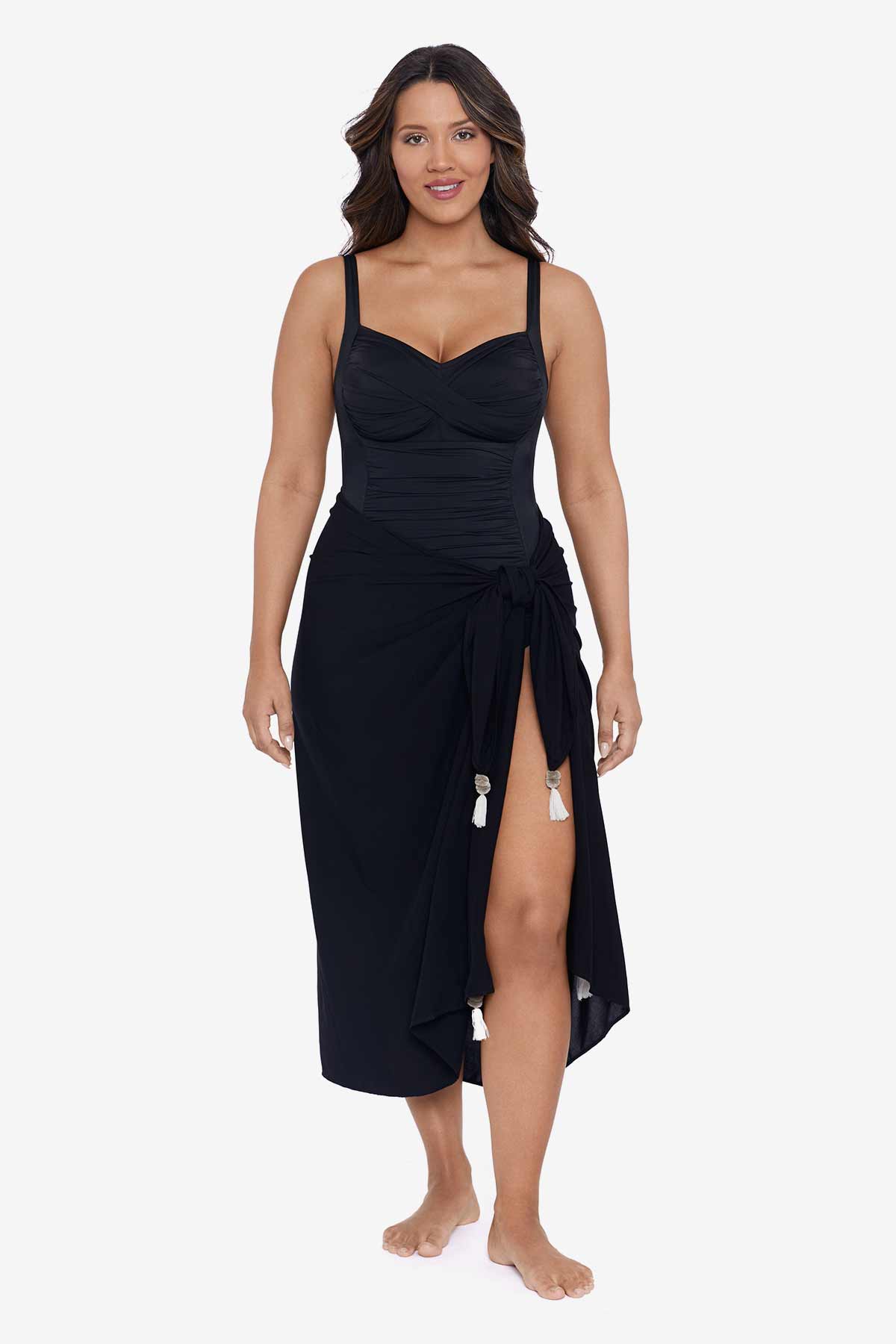 Woman wearing a black swim wrap cover up with tassels